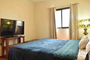 a bedroom with a bed and a flat screen tv at Casa Palma in La Paz