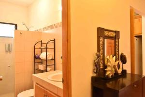 a bathroom with a sink and a toilet and a mirror at Casa Palma in La Paz +22 photos