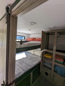 a room with two bunk beds in a trailer at H&K Acres in Rutland
