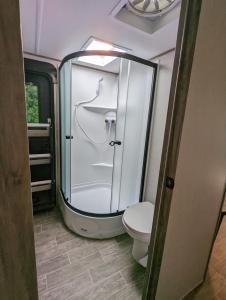 a bathroom with a toilet and a glass shower at H&K Acres in Rutland
