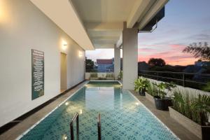 a swimming pool on the roof of a house at KHAS Tegal Hotel in Tegal