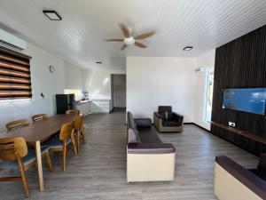 a dining room with a table and a ceiling fan at TANJUNG GROVE VILLAS 