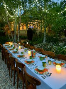 a long table with plates and candles on it at Rent your own Historic Hotel for Holidays & Events in Maldon