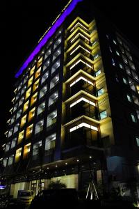 a large building with lights on it at night at Central Park Tower Resort in Angeles