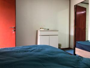a bedroom with a blue bed and a white cabinet at Tiongman Scubadive & Lodge in Tioman Island