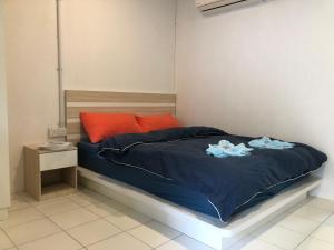 a bed with blue sheets and two dolls on it at Tiongman Scubadive & Lodge in Tioman Island