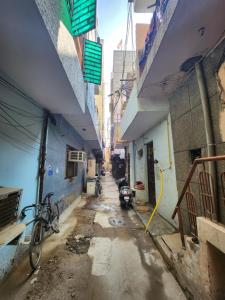 an alley with a bike parked in an alley between buildings at Homlee-Heritage 2-Bed Room Apt near Pragati Maidan in New Delhi
