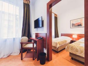 Łóżko lub łóżka w pokoju w obiekcie Hotel Chmielna Warsaw