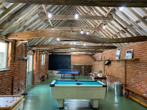 a room with a ping pong table in it at The Stables in Colchester