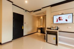Zimmer mit einer schwarzen Tür und einem Flachbild-TV in der Unterkunft Pranee Home Phang-nga in Ban Khaek