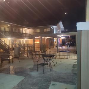 a patio with tables and chairs at night at Terrace Park Inn in Fort Morgan