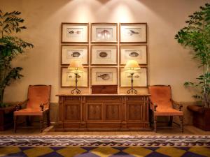 a room with two chairs and a table with two lamps at Hotel Nikko Alivila in Yomitan