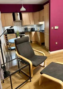 a kitchen with a chair and a table in it at Two Bedroom Entire Flat in Darlington with Free Parking, WiFi and lots more in Darlington