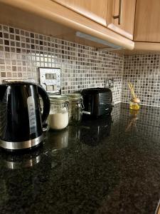 a kitchen counter top with a toaster and a toaster and a toaster at Two Bedroom Entire Flat in Darlington with Free Parking, WiFi and lots more in Darlington