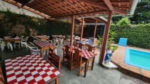 a patio with tables and chairs and a swimming pool at BUONA SORTE in Lençóis