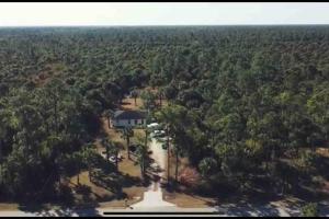 an aerial view of a house in the middle of a forest at Rv for up to 6 people in Naples