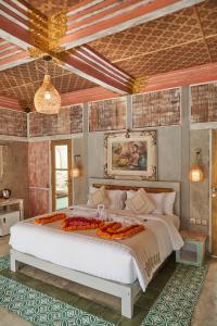 a bedroom with a large white bed in a room at Casa Batu Belig in Seminyak