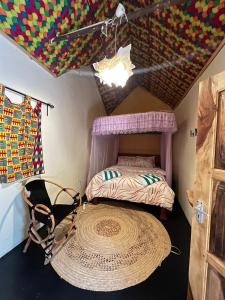 a bedroom with a bed and a large rug at Green Garden Guest House in Arusha