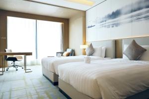 Postel nebo postele na pokoji v ubytování Metropark Hotel Hongqiao Shanghai
