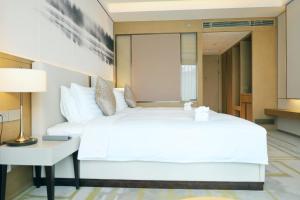 Postel nebo postele na pokoji v ubytování Metropark Hotel Hongqiao Shanghai