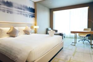 Postel nebo postele na pokoji v ubytování Metropark Hotel Hongqiao Shanghai