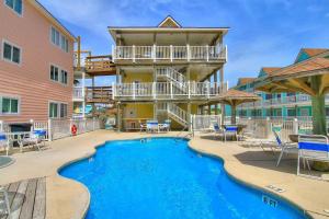 a resort with a swimming pool and a building at BeachGate CondoSuites and Oceanfront Resort in Port Aransas