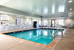 a large swimming pool in a hotel room at Staybridge Suites - Lafayette, an IHG Hotel in Lafayette