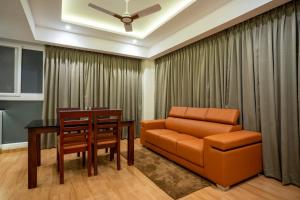 a living room with a couch and a table at AS Inn in Ernakulam