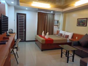 a hotel room with a bed and a couch at FLOROTEL II in General Santos