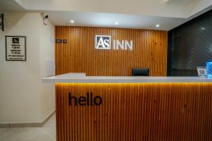 an asimo counter in an office with a hello sign on it at AS Inn in Cochin