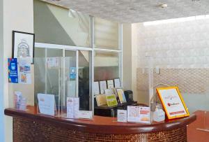 a counter in a store with signs on it at RedDoorz Plus New Era Budget Hotel Mabolo former RedDoorz near Landers Superstore Cebu City in Cebu City