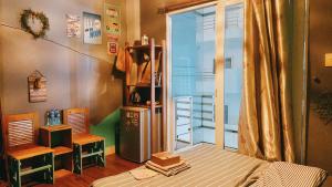 a room with a bed and a sliding glass door at Cozy Room@SaiGon in Ho Chi Minh City