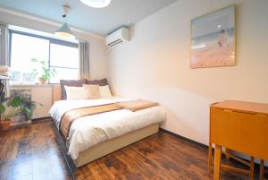 niewielka sypialnia z łóżkiem i biurkiem w obiekcie Comfy Stay Sakuramachi w mieście Nara