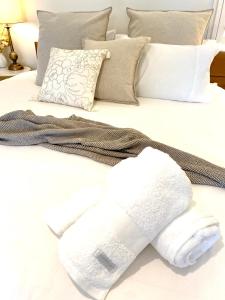 a white towel on top of a bed with pillows at Casuarina Beach 2 bedroom retreat in Casuarina