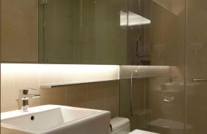 a bathroom with a sink and a toilet and a mirror at Days Hotel by Wyndham Seoul Myeongdong in Seoul
