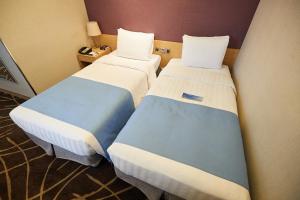 Łóżko lub łóżka w pokoju w obiekcie Days Hotel by Wyndham Seoul Myeongdong