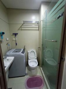 a bathroom with a toilet and a sink and a shower at Cozypura Staycation at S Residences Mall of Asia Complex Pasay City in Manila