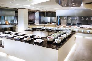 a kitchen with many bowls of food on a counter at Westin Josun Seoul Hotel in Seoul