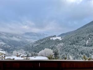 a view of a snowy mountain with houses and trees at Hotel San Carlo, tra Bormio e Livigno in Valdidentro