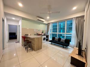 a kitchen and living room with a couch and a table at KGS HOME at Sutera Avenue Kota Kinabalu Area KK City Opposite Imago in Kota Kinabalu