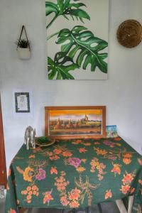 a bedroom with a bed with a green comforter at Sumatra Orangutan Discovery Villa in Bukit Lawang