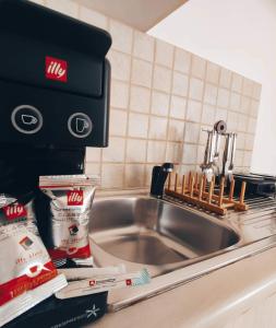 a kitchen counter with a sink and a kitchenaidadobeadobeadobeadobeadobeadobe at Alezina studios in Amorgos