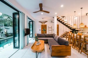 a living room with a couch and a table at Terra Villas in Ahangama