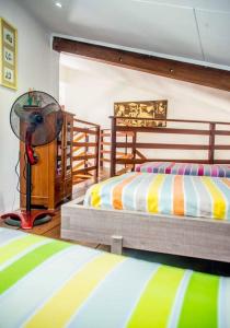 a bedroom with two twin beds and a fan at Villa Le Lion de Mer in Saint-Pierre