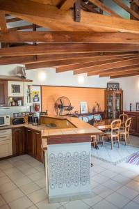 a kitchen with wooden ceilings and a table and chairs at Villa Le Lion de Mer in Saint-Pierre