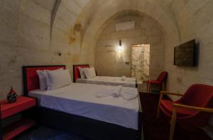 Postel nebo postele na pokoji v ubytování The Niche Cave Hotel