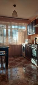 a kitchen with a washing machine and a table at Центр 3 слободская АТБ in Mykolaiv