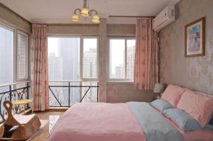 a bedroom with a large bed and a balcony at Xiao Yu B&B Apartment Near Jiefangbei and Hongyadong in Chongqing