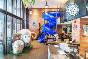 a restaurant with two large stuffed animals on the counter at Kokotel Bangkok Surawong in Bangkok