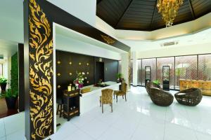 a lobby with a bar with chairs and a table at Kacha Resort & Spa, Koh Chang in Ko Chang